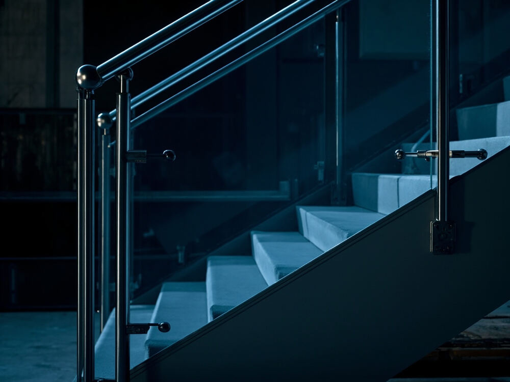 Stainless steel railing with glass panels on a staircase